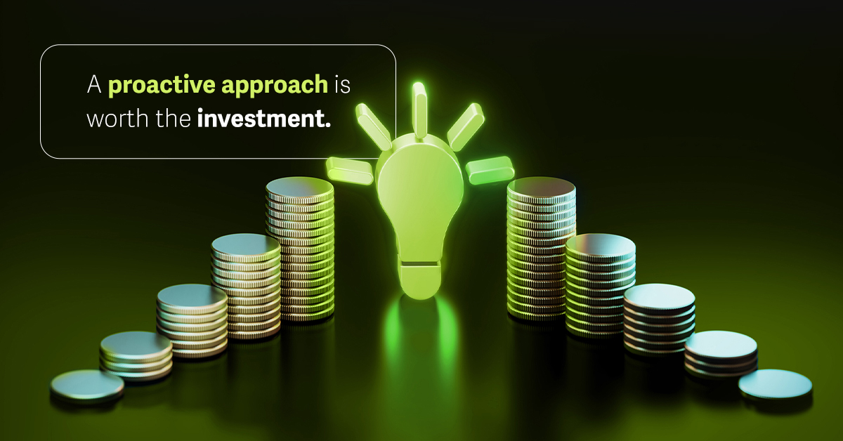 A green lightbulb and stacks of coins